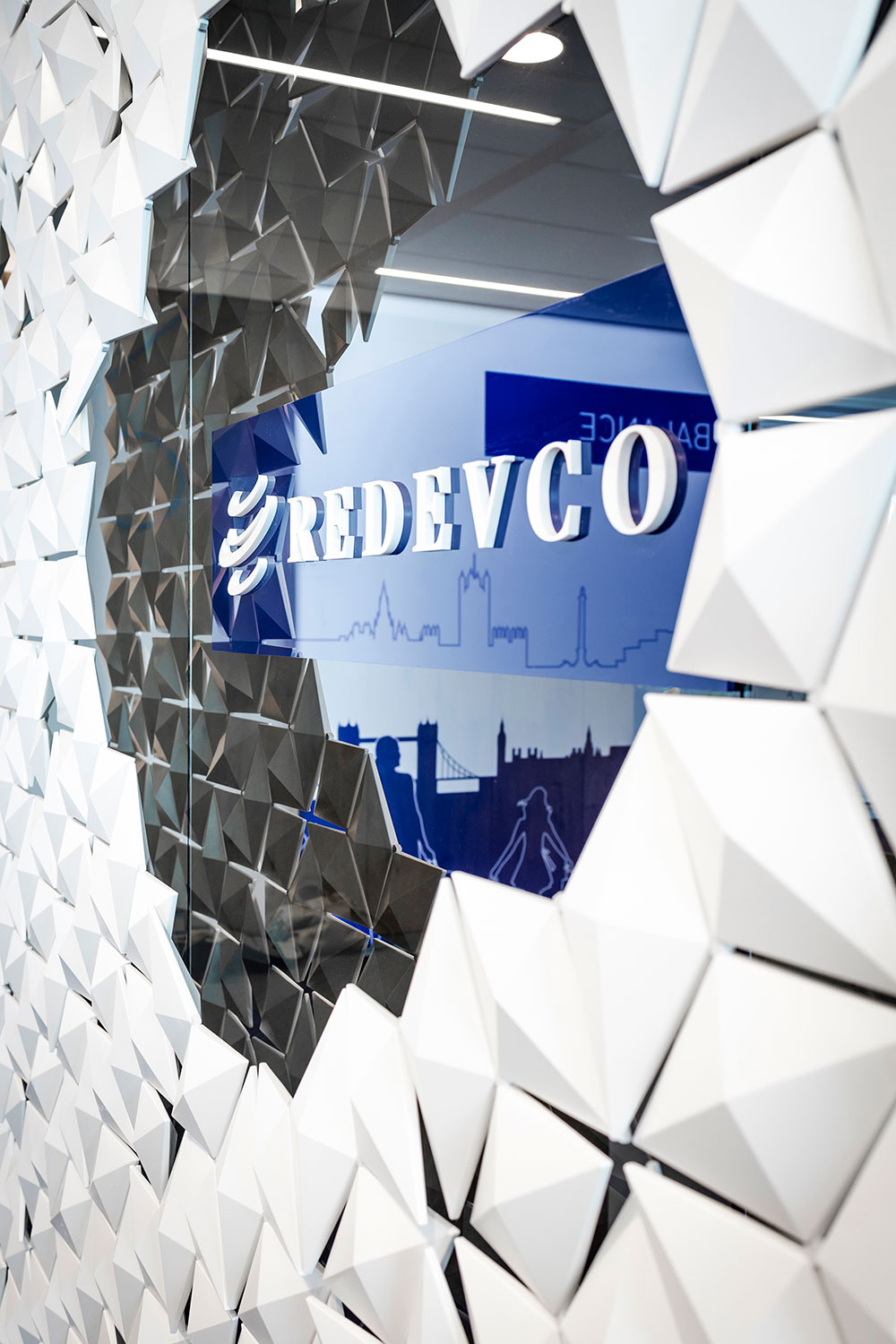 Detail of large office partition with integrated branding framing Redevco logo