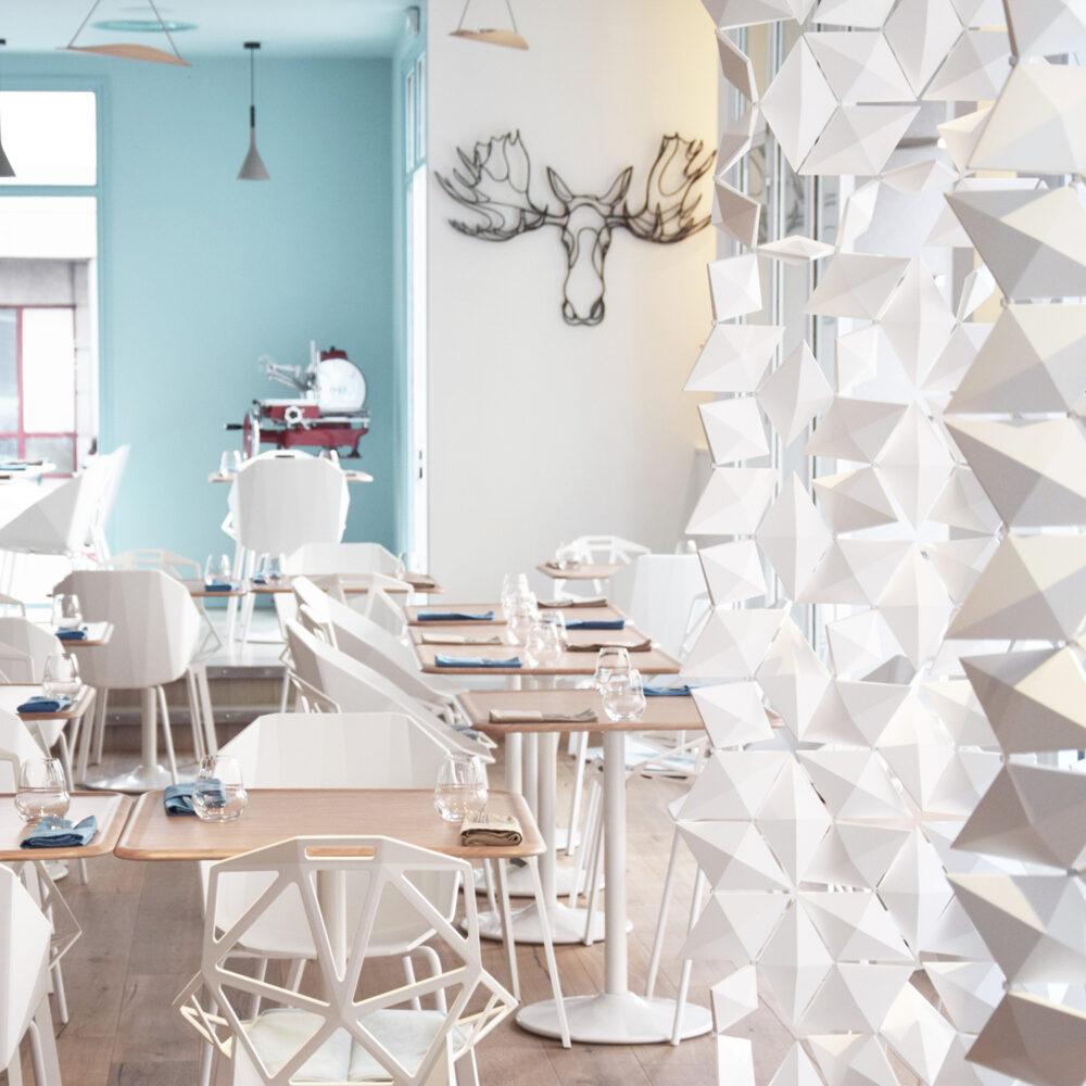Restaurant partitions creating depth and zoning in Scandinavian restaurant interior