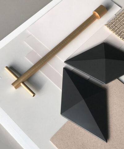 Anodized gold suspension with Facet hanging room divider in a designer interior setting