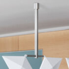 Brushed stainless steel suspension with Facet hanging room divider installed on a white ceiling in a modern interior