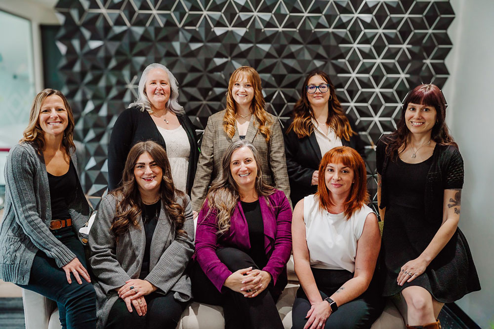 Team in front of modular office partition in creative workspace