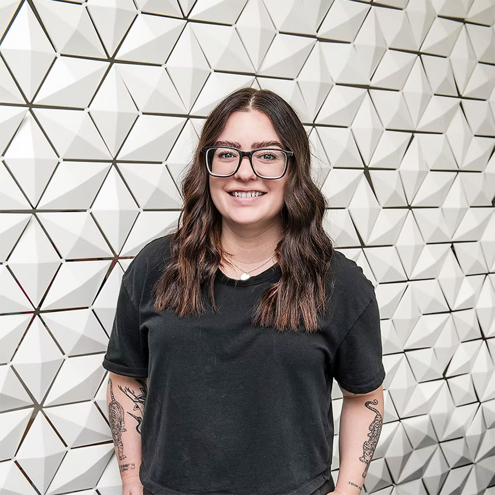 Geometric room divider in a creative workspace with employee portrait